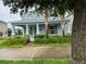 Charming blue two-story home with well-manicured landscaping and a welcoming front porch at 7530 Summerlake Groves St, Winter Garden, FL 34787