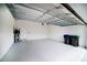 Spacious garage with overhead storage racks, and side utility door at 7530 Summerlake Groves St, Winter Garden, FL 34787