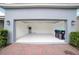 Spacious two-car garage featuring painted walls, an automatic door, and ample room for vehicles and storage at 7530 Summerlake Groves St, Winter Garden, FL 34787