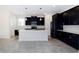 Modern kitchen featuring dark cabinetry, a large center island, and stainless steel appliances at 7530 Summerlake Groves St, Winter Garden, FL 34787