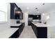 Bright, open kitchen with a spacious island, stylish dark cabinetry, and stainless steel appliances at 7530 Summerlake Groves St, Winter Garden, FL 34787