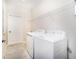 Bright laundry room with modern washer and dryer, plus wire rack for storage at 7530 Summerlake Groves St, Winter Garden, FL 34787