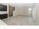 Open-concept living room with large windows, tile flooring and an adjacent kitchen space at 7530 Summerlake Groves St, Winter Garden, FL 34787