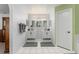 Bathroom featuring dual sinks, stylish hardware, white cabinets, and modern lighting at 7764 Indian Ridge N Trl, Kissimmee, FL 34747