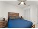Comfortable bedroom featuring a ceiling fan, natural light, a cozy bed, and wood furniture at 7764 Indian Ridge N Trl, Kissimmee, FL 34747