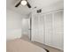 Bedroom with white closet doors and access to bathroom through open door at 7764 Indian Ridge N Trl, Kissimmee, FL 34747