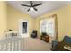 Bright bedroom with carpet, yellow walls, a window with curtains, and comfortable seating at 7764 Indian Ridge N Trl, Kissimmee, FL 34747
