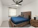 Comfortable bedroom featuring a ceiling fan, natural light, a cozy bed, and wood furniture at 7764 Indian Ridge N Trl, Kissimmee, FL 34747