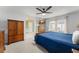 Comfortable bedroom featuring a ceiling fan, carpet, natural light, a cozy bed, and wood furniture at 7764 Indian Ridge N Trl, Kissimmee, FL 34747