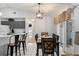 Dining room with an elegant light fixture, a bar, and sliding glass doors to the exterior at 7764 Indian Ridge N Trl, Kissimmee, FL 34747