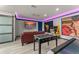 Bright game room features foosball, arcade games, and comfortable seating for endless entertainment at 7764 Indian Ridge N Trl, Kissimmee, FL 34747