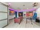 Entertainment room with a large TV, game tables, and unique decorative wall art at 7764 Indian Ridge N Trl, Kissimmee, FL 34747