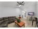Bright living room featuring vaulted ceilings, modern flooring, and a cozy seating area at 7764 Indian Ridge N Trl, Kissimmee, FL 34747