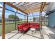 Covered patio features comfortable seating with a view of the pool and screened enclosure at 7764 Indian Ridge N Trl, Kissimmee, FL 34747