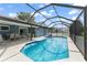 Spacious in-ground pool features screened enclosure and outdoor seating at 7764 Indian Ridge N Trl, Kissimmee, FL 34747
