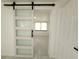 Bedroom entrance with frosted glass barn door at 817 Clay Blvd, Eustis, FL 32726