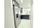 Modern kitchen features sleek, gray cabinetry, stainless steel appliances, quartz countertops, and light wood floors at 817 Clay Blvd, Eustis, FL 32726