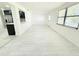 Spacious living room with light wood floors seamlessly flowing into the kitchen, with an open and airy layout at 817 Clay Blvd, Eustis, FL 32726