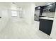 Open-concept living room seamlessly connects to the modern kitchen, offering an inviting and spacious living space at 817 Clay Blvd, Eustis, FL 32726