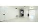Bright and airy living room features light wood floors, fresh white paint, and a seamless flow into the kitchen at 817 Clay Blvd, Eustis, FL 32726