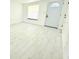 Bright living room with a large front window and light wood floors at 817 Clay Blvd, Eustis, FL 32726