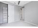 Bright bedroom with a sliding door closet and a view into the en suite bathroom and hallway at 8290 Nemours Pkwy, Orlando, FL 32827