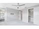 Bright bedroom with carpet flooring and a glimpse into the en suite bathroom and spacious walk-in closet at 8290 Nemours Pkwy, Orlando, FL 32827