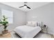 Bright bedroom showcasing a comfortable bed, a modern ceiling fan, and a neutral color palette for a soothing ambiance at 8290 Nemours Pkwy, Orlando, FL 32827
