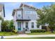 Charming two-story home with a well-maintained lawn, front porch, and a teal front door at 8290 Nemours Pkwy, Orlando, FL 32827