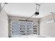 Modern garage with glass panel door and automatic opener, providing secure parking and natural light at 8290 Nemours Pkwy, Orlando, FL 32827