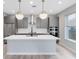 Modern kitchen with stainless steel appliances and large island, ideal for cooking and gathering at 8290 Nemours Pkwy, Orlando, FL 32827