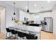 Modern kitchen featuring white cabinets, granite counters, stainless steel appliances, and a breakfast bar at 8290 Nemours Pkwy, Orlando, FL 32827