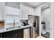 Well-lit kitchen features granite countertops, stainless steel appliances, and ample cabinet space at 8290 Nemours Pkwy, Orlando, FL 32827