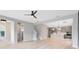 Large living room with modern kitchen in the background featuring stainless steel appliances at 8290 Nemours Pkwy, Orlando, FL 32827