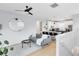 Bright, open-concept living area with hardwood floors, comfortable seating, and modern kitchen at 8290 Nemours Pkwy, Orlando, FL 32827