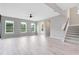 Spacious living room filled with natural light and stairs to the next floor at 8290 Nemours Pkwy, Orlando, FL 32827