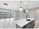 Open concept living space with island and stainless steel appliances, perfect for entertaining at 8290 Nemours Pkwy, Orlando, FL 32827