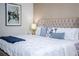 Close-up of a comfortably furnished bed with decorative pillows and a tufted headboard, offering a cozy feel at 9071 Sunshine Ridge Loop, Kissimmee, FL 34747