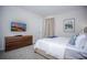 Bright bedroom with a TV, stylish dresser, and neutral decor, creating a relaxing atmosphere at 9071 Sunshine Ridge Loop, Kissimmee, FL 34747