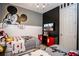 Themed bedroom features Mickey Mouse accents, providing a whimsical and playful space for children at 9071 Sunshine Ridge Loop, Kissimmee, FL 34747