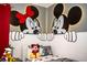 Themed bedroom featuring Mickey and Minnie Mouse wall decor, providing a playful and whimsical space at 9071 Sunshine Ridge Loop, Kissimmee, FL 34747