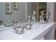 Close-up of elegant silver hand sculptures displayed on a white console table with a large mirror at 9071 Sunshine Ridge Loop, Kissimmee, FL 34747