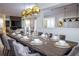 A spacious dining area with modern decor and a view into the living area at 9071 Sunshine Ridge Loop, Kissimmee, FL 34747