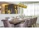 Dining room featuring a large dining table set for a formal meal, with elegant chairs and gold pendant lighting at 9071 Sunshine Ridge Loop, Kissimmee, FL 34747