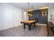 A game room with a pool table, unique lighting, and bar stools for entertaining at 9071 Sunshine Ridge Loop, Kissimmee, FL 34747