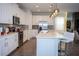 Modern kitchen with stainless steel appliances, white cabinetry, and a breakfast bar at 9071 Sunshine Ridge Loop, Kissimmee, FL 34747