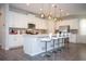 Kitchen features white cabinetry, stainless steel appliances, and a large island with seating at 9071 Sunshine Ridge Loop, Kissimmee, FL 34747