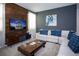 Comfortable living room featuring a stylish TV console, large TV, and cozy sofa, perfect for relaxing at 9071 Sunshine Ridge Loop, Kissimmee, FL 34747