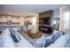 Open-concept living room featuring a modern fireplace, kitchen with bar seating, and comfortable furnishings at 9071 Sunshine Ridge Loop, Kissimmee, FL 34747