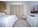 Bright and airy main bedroom with large bed, accent chair, dresser and television at 9071 Sunshine Ridge Loop, Kissimmee, FL 34747